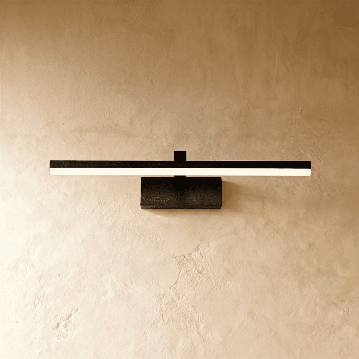 Clérachic black linear wall light with a slender light bar mounted flush on a plaster wall via a rectangular base.