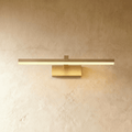 Clérachic brass linear wall light with a slim horizontal bar and rectangular wall plate glowing warm on plaster.