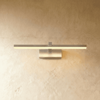Clérachic silver linear wall light with a slim horizontal bar and rectangular wall plate against a plaster wall.
