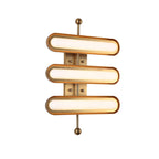 On a white backdrop, three stacked frosted capsule lights in gold rims run along a gold backplate and a rod with round ends, from Clérachic.
