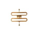 A two-capsule Clérachic wall light with frosted white lenses in gold rims on a brass backplate, shown on white.