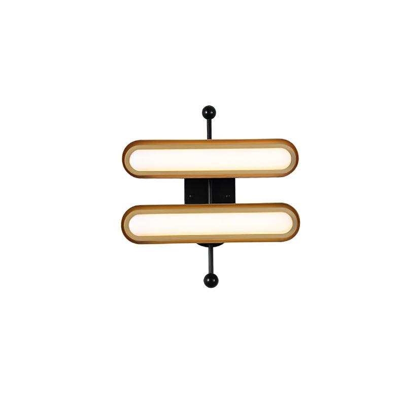 Two capsule lenses in gold rims on a black backplate and rod with black ends, on white, from Clérachic.