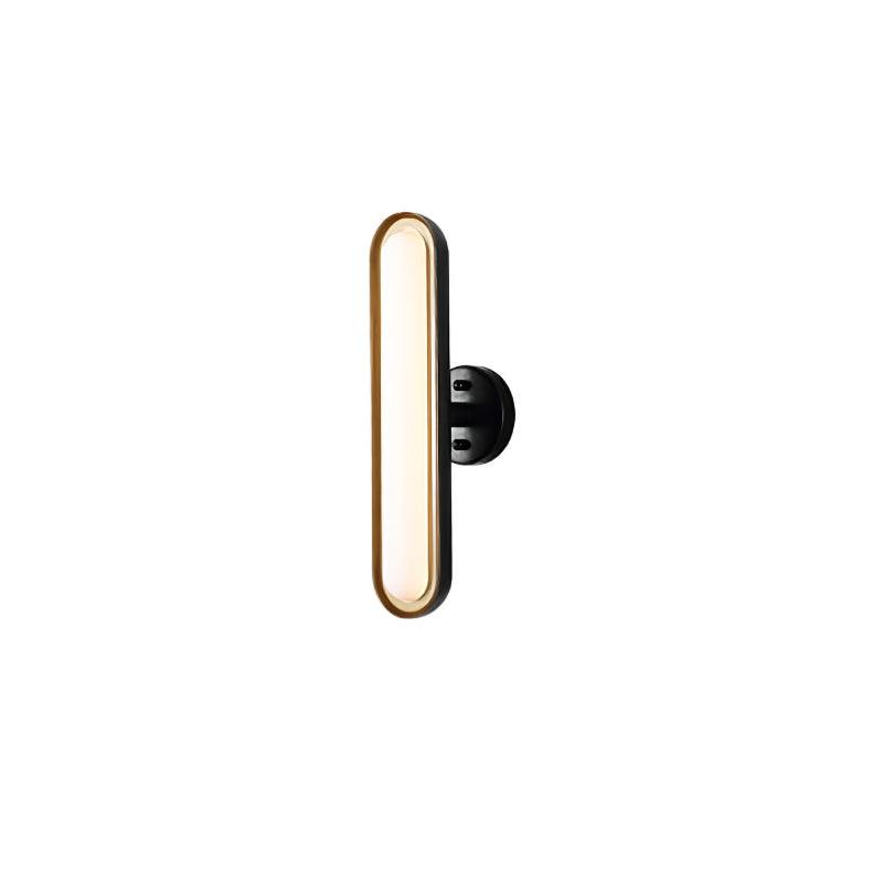 A single Clérachic capsule wall light lit warm on white, with a gold-edged frosted lens and a round black wall plate at the side.
