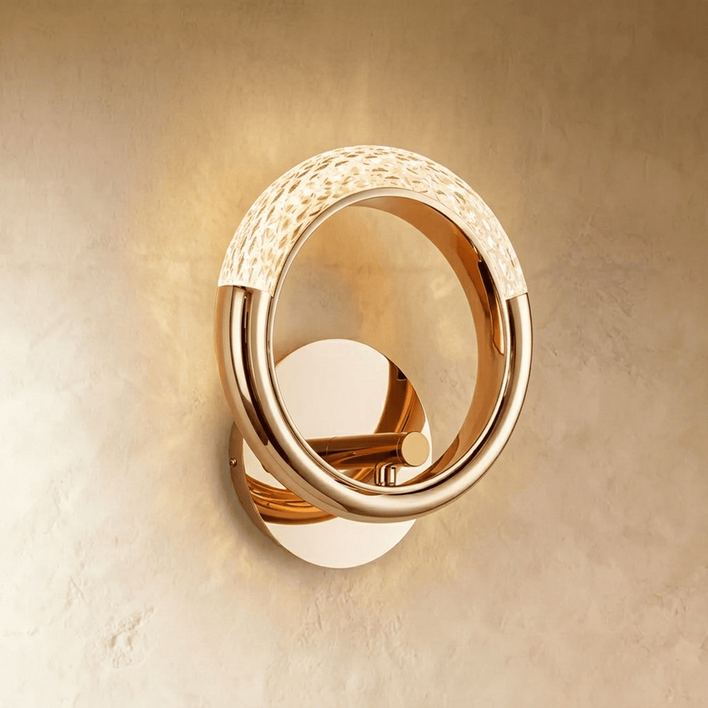 Clérachic polished gold ring wall lamp with a pebbled acrylic arc across the top, mounted on a round gold backplate.