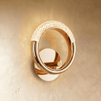 Clérachic polished gold ring wall lamp with a pebbled acrylic arc across the top, mounted on a round gold backplate.