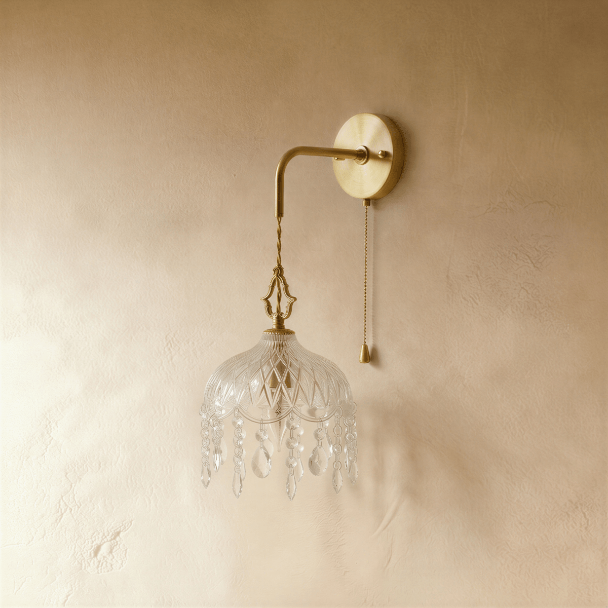Clérachic unlit wall lamp: gold arm, twisted cord and cut-glass dome fringed with crystal drops, pull chain beside.