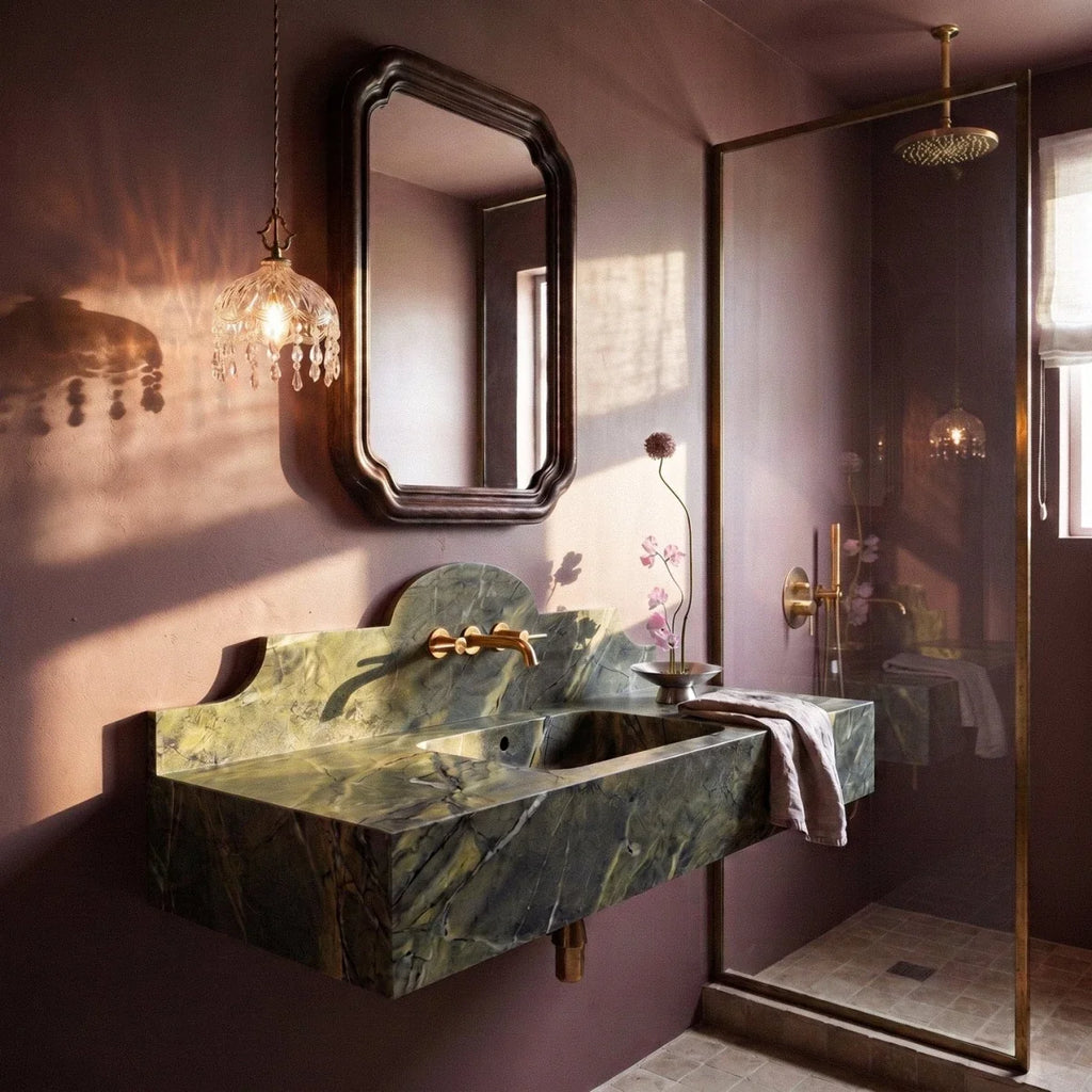 Clérachic crystal-fringed glass pendant beside a mirror above a green stone basin in a plum-toned bathroom.