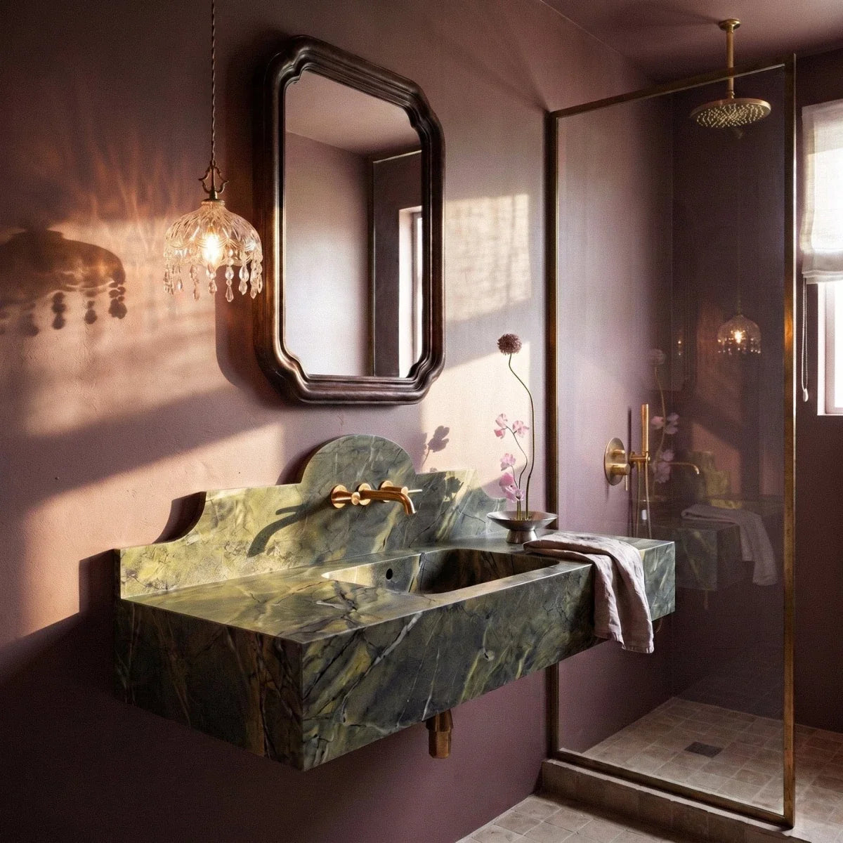 Clérachic crystal-fringed glass pendant beside a mirror above a green stone basin in a plum-toned bathroom.