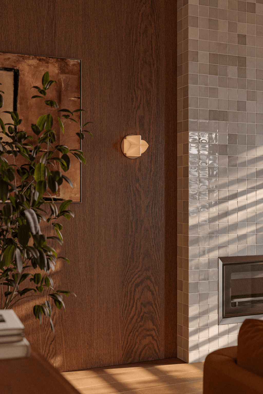 A tiny cream Clérachic wall light on a wood-panelled wall beside a glazed tile fireplace surround and a leafy plant.