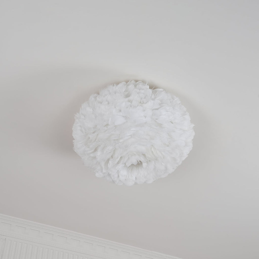 Unlit white feather ceiling light from Clérachic with an open centre underneath, hung flush on a white ceiling by a cornice.