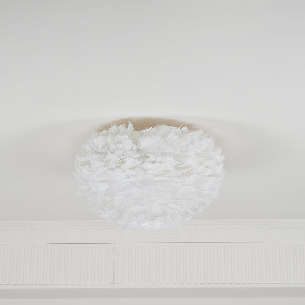 Smaller white feather ceiling light from Clérachic unlit on a white ceiling above a plaster cornice.