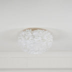 Smaller white feather ceiling light from Clérachic unlit on a white ceiling above a plaster cornice.