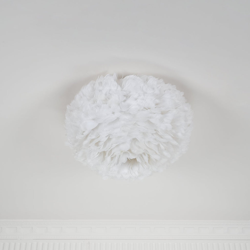 Larger white feather ceiling light from Clérachic unlit and seen at an angle, with a small opening at the base.