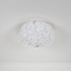 Larger white feather ceiling light from Clérachic unlit and seen at an angle, with a small opening at the base.
