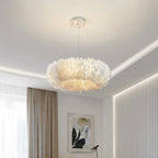 Above a bedroom with a cove-lit ceiling and taupe curtains, this Clérachic pendant shows a lit ring of layered white feathers.