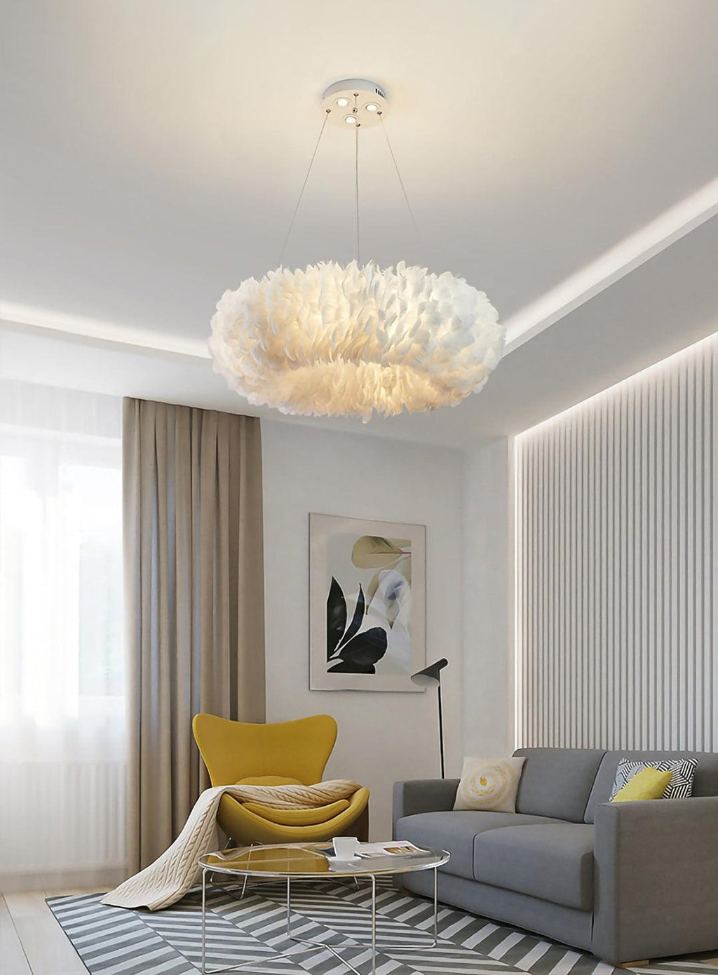 A Clérachic feather ring pendant hangs above a grey sofa, a yellow armchair and a round coffee table in a living room.