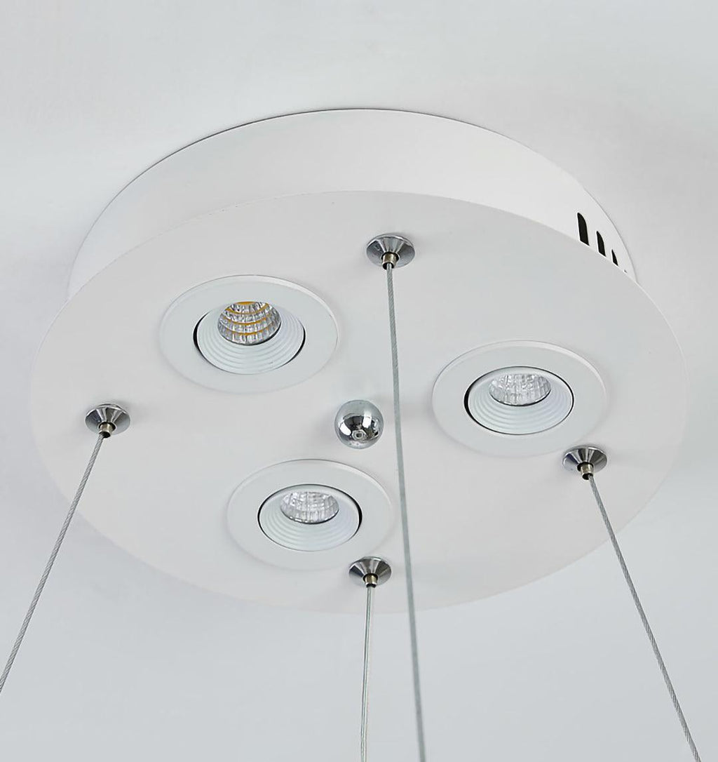 Underside of this Clérachic pendant's round white canopy, showing three small recessed spotlights and the steel cable fixings.
