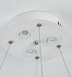 Underside of this Clérachic pendant's round white canopy, showing three small recessed spotlights and the steel cable fixings.