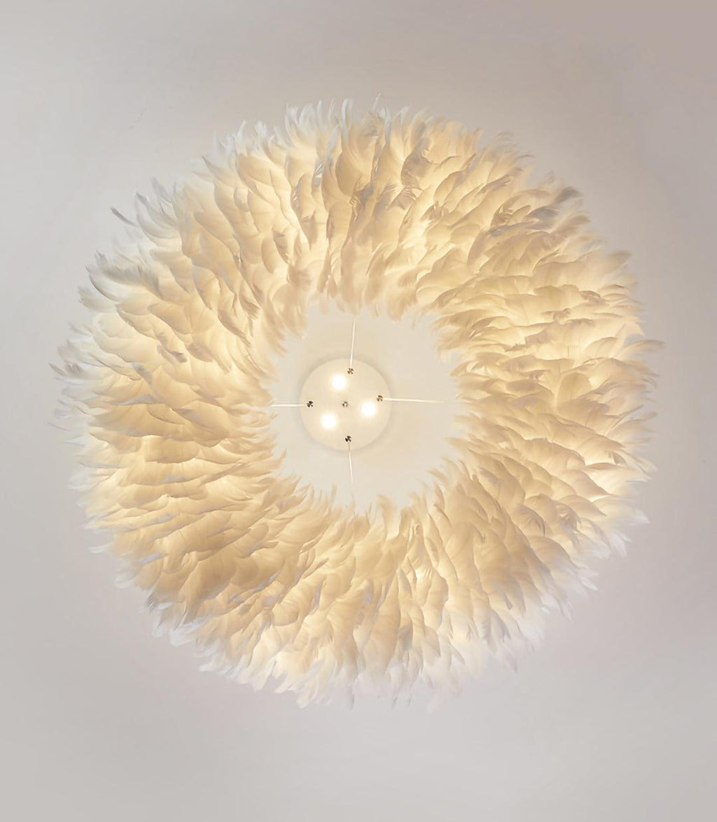 Looking straight up at the lit feather ring of this Clérachic pendant, with its canopy and spotlights at the centre.