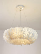 The same Clérachic ring pendant with its glow slightly lower, shown against a pale wall under a white ceiling.