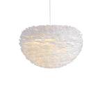 A Clérachic feather pendant with a deep dome shape, unlit, hanging on a white cable against a white backdrop.