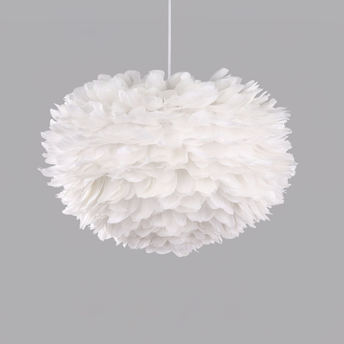 A round, fluffy Clérachic feather pendant, unlit, on a white cable against a flat grey background.
