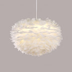 A full, rounded Clérachic feather pendant on a white cable against a muted mauve-grey backdrop.