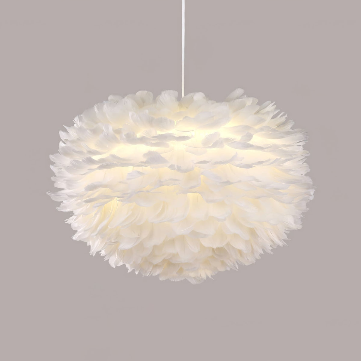 A full, rounded Clérachic feather pendant on a white cable against a muted mauve-grey backdrop.