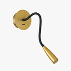 Gold Clérachic wall light on a plain white backdrop, its black flexible arm curving down to a tapered gold spot head.