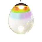 Front view of this Clérachic glass pendant on white, its clear shade graded from gold and green near the top to turquoise and pink.