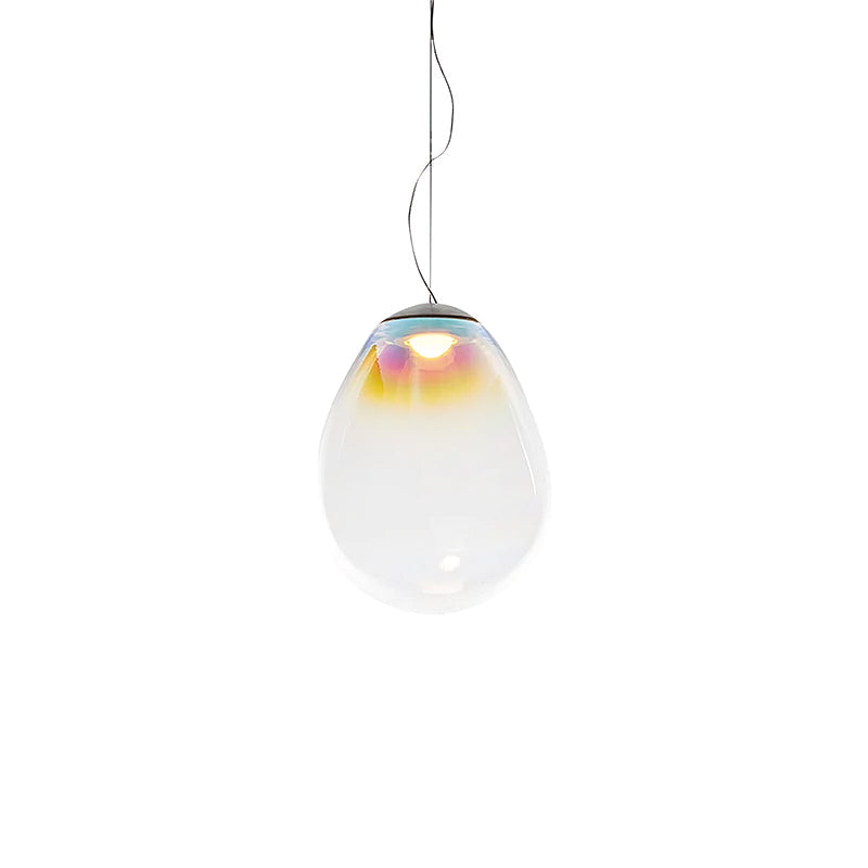 A small, thin-corded Clérachic glass pendant on white, its clear teardrop shade tinted gold and blue near the top.