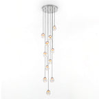 Render of a long Clérachic cluster with many glass teardrop pendants at varied heights from one round chrome ceiling plate.