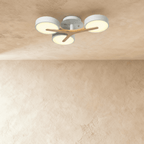 Clérachic's ceiling light in white with a light wood cross arm, three round diffusers glowing softly overhead.