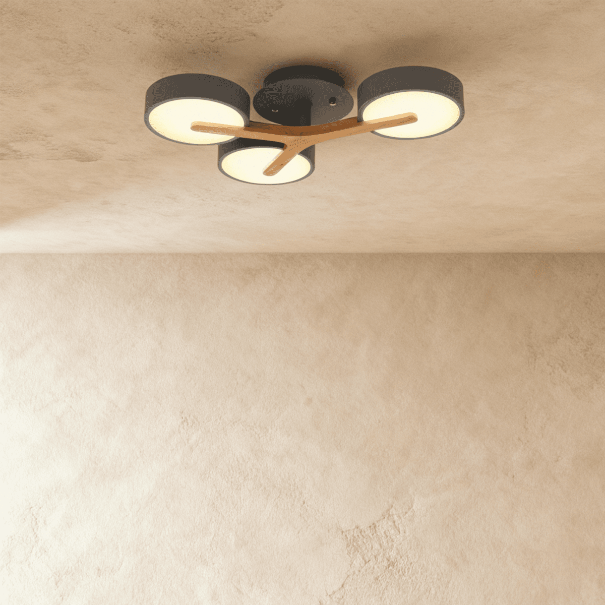 Clérachic's ceiling light in charcoal gray, three round shades mounted on a light wood cross arm overhead.