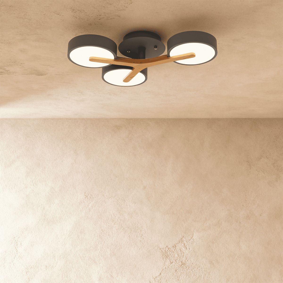 A closer view of the Clérachic ceiling light in gray, showing its three illuminated diffusers and wood arm.