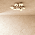 Clérachic's ceiling light in white, a seven-head cluster with light wood branches radiating from the centre.