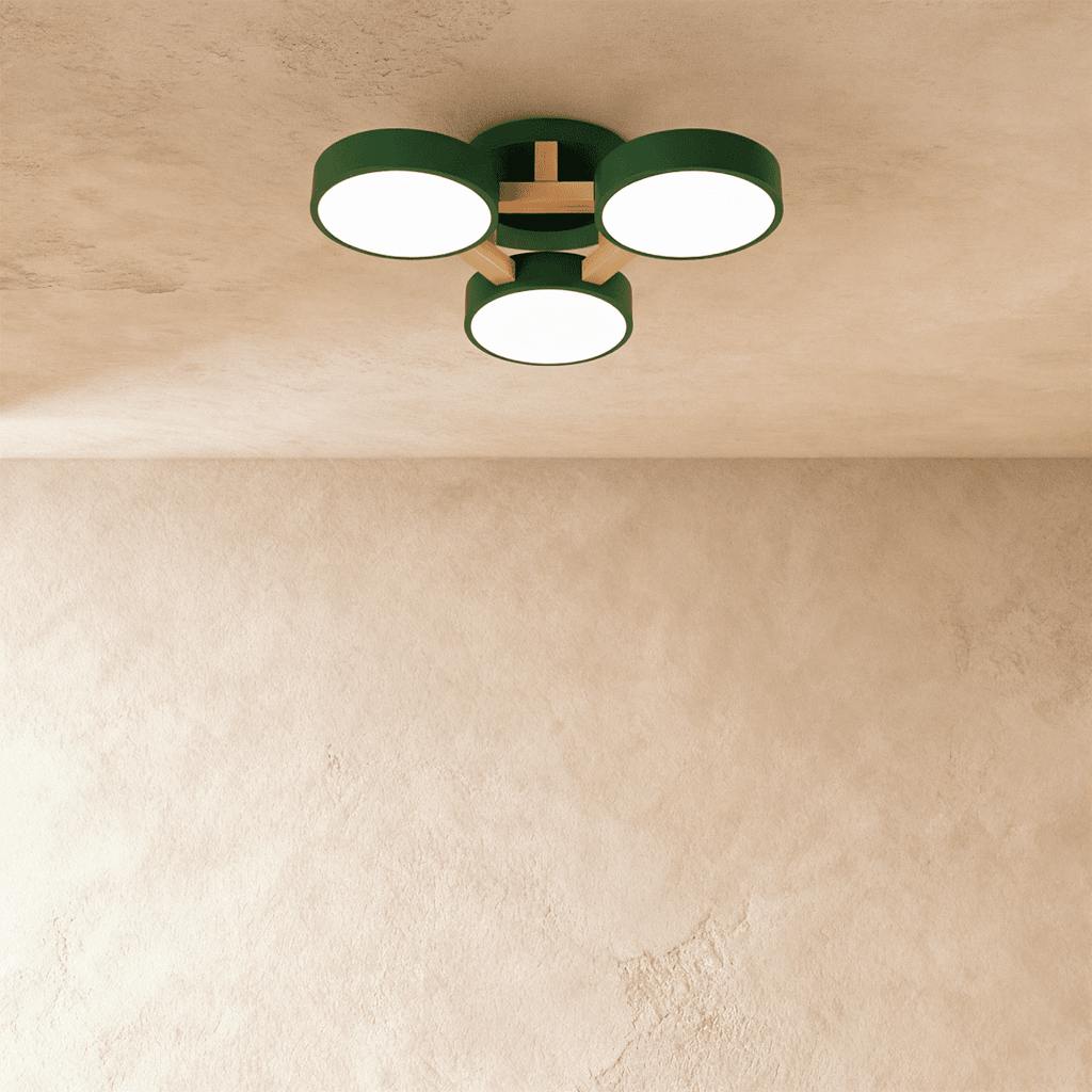 Clérachic's ceiling light in green, three drum shades on a light wood cross bar, photographed from below.