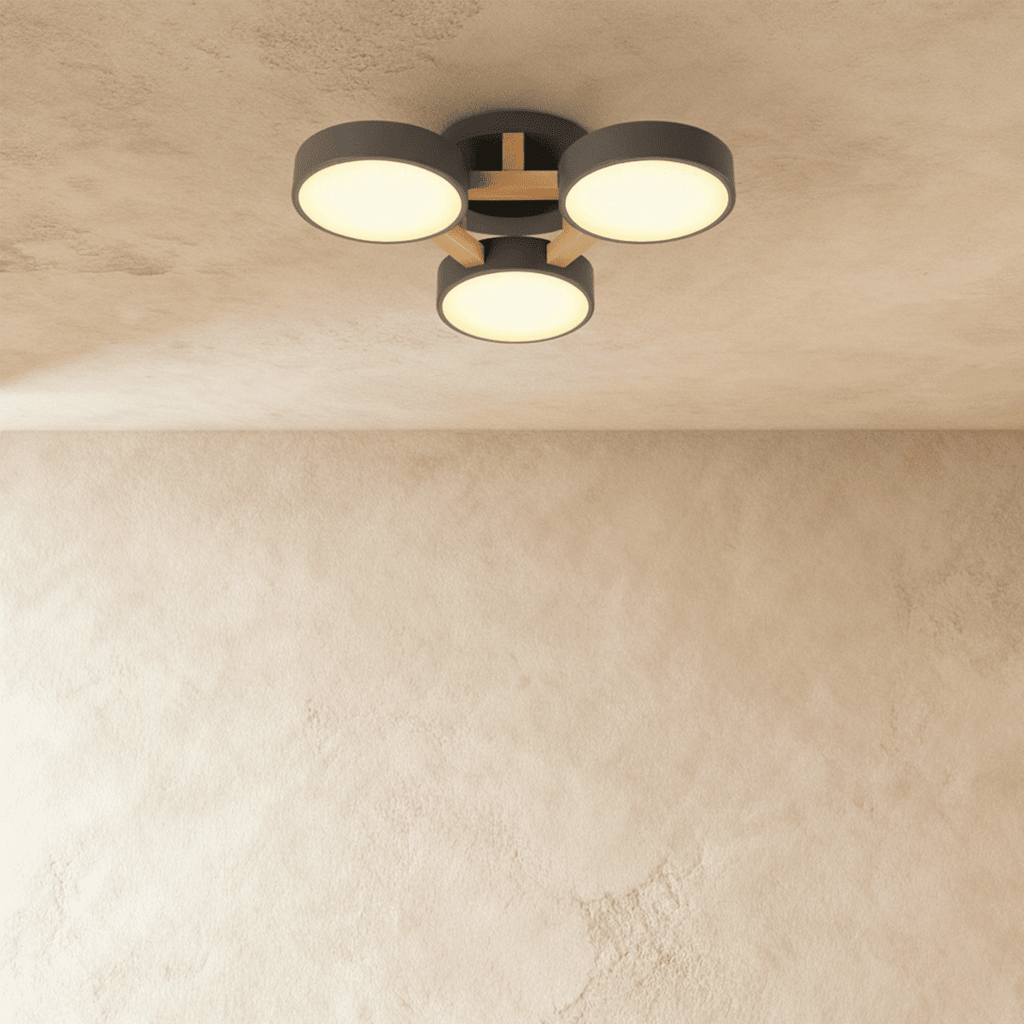 The Clérachic ceiling light in gray, its three drum diffusers glowing softly against the ceiling above.