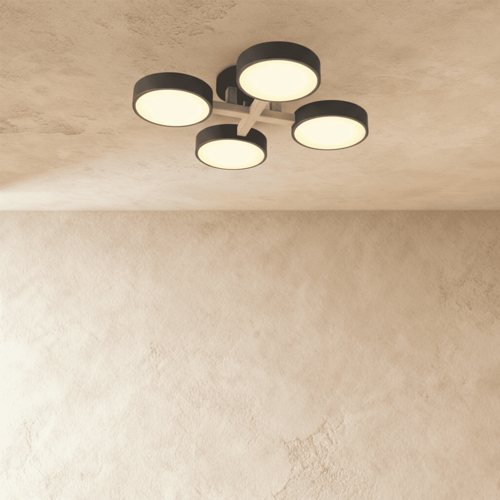 The Clérachic ceiling light in gray, its four drum diffusers glowing warmly against the ceiling above.