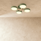 A closer view of the Clérachic ceiling light in green, showing the four-head branching arrangement lit.