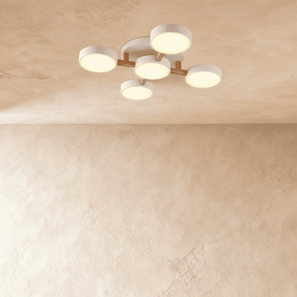 Clérachic's ceiling light in white, five drum shades branching irregularly from a light wood arm overhead.