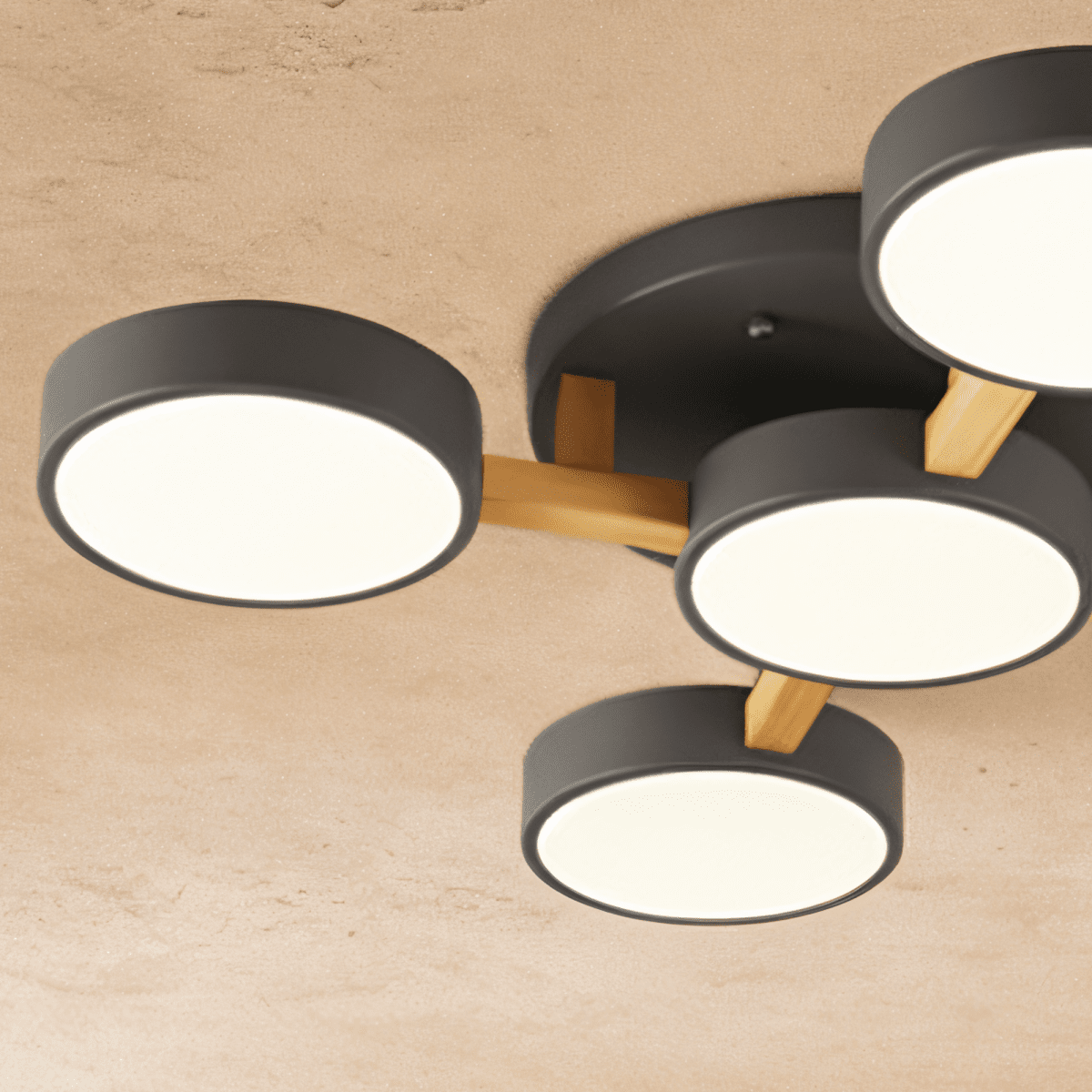 A close detail of the Clérachic ceiling light in gray, showing the light wood cross-joint at its centre.