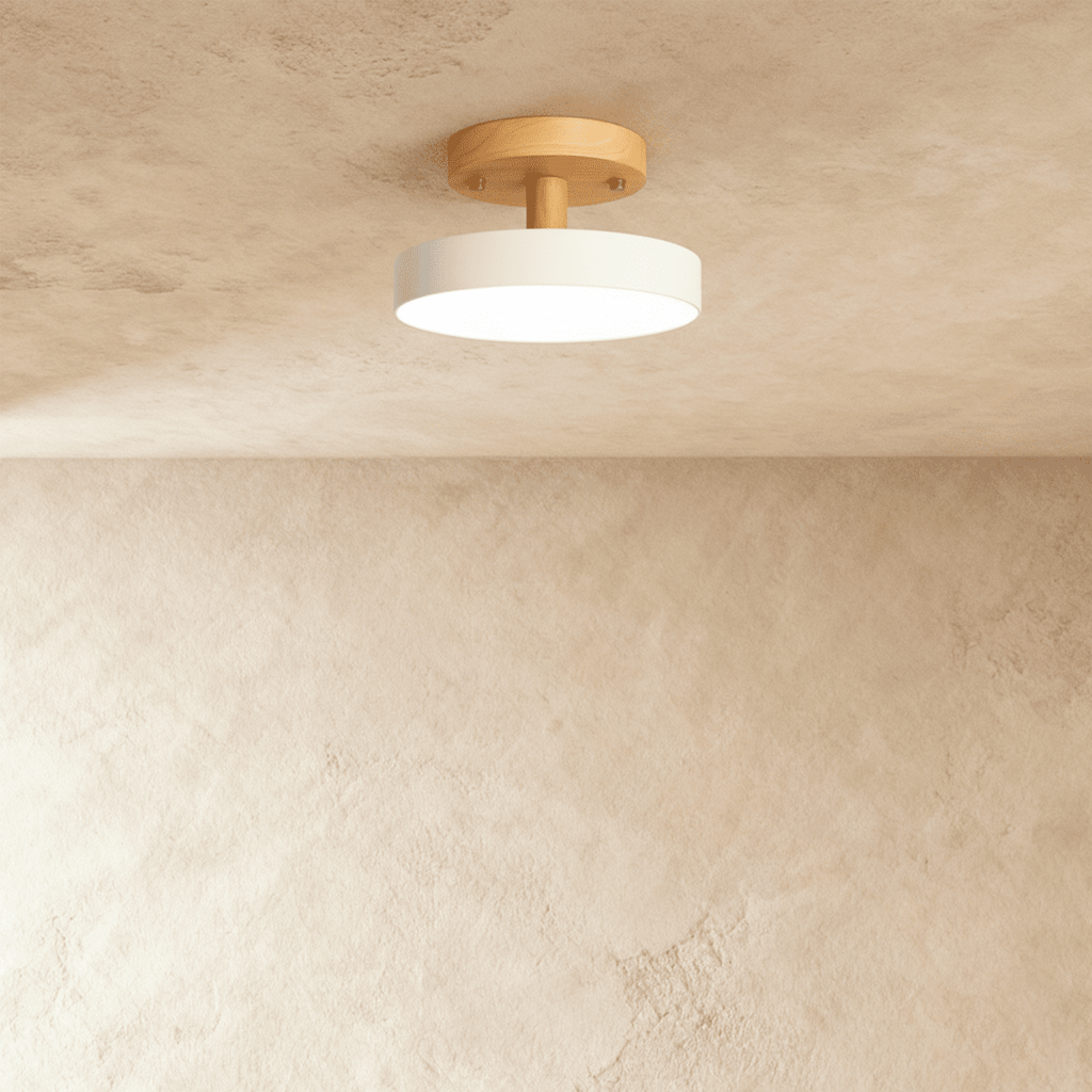 Clérachic's ceiling light in white, a single round diffuser on a light wood ceiling plate, semi-flush mount.