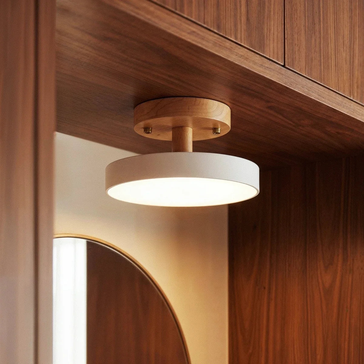A close lifestyle view of the Clérachic ceiling light in white, mounted beneath a walnut cabinet shelf.