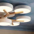 A close lifestyle detail of the Clérachic ceiling light, showing its branching wood arms and round diffusers.