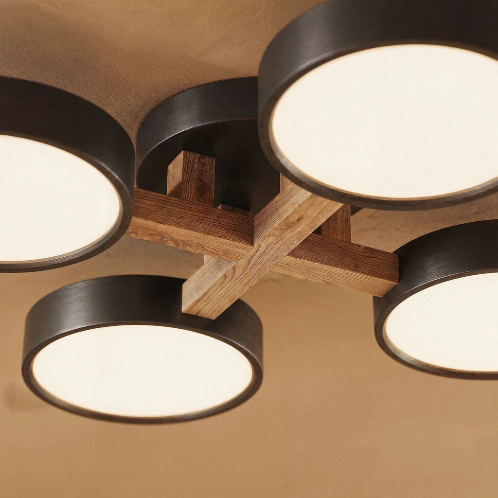 A close detail of the Clérachic ceiling light in gray, showing the light wood cross-joint at its centre.