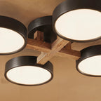 A close detail of the Clérachic ceiling light in gray, showing the light wood cross-joint at its centre.