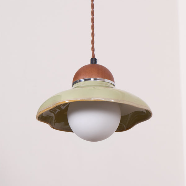 Clérachic green pendant on a twisted brown cord, with a flared ceramic shade and a round white globe below.