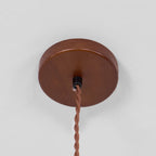 Round walnut-coloured ceiling canopy with a twisted brown cord hanging from it, for this Clérachic pendant.
