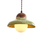 Clérachic green ceramic pendant with a glowing warm globe on a twisted brown cord, on a white background.